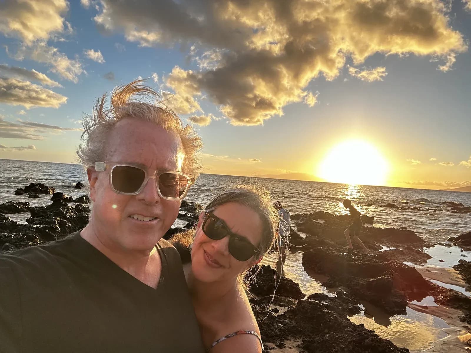 Anthony Eddolls and his wife, Chris, by the ocean at sunset